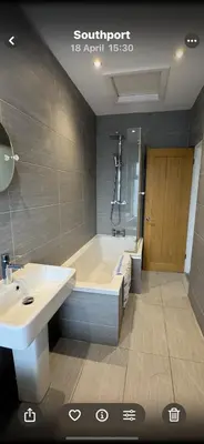 a bathroom with a bath tub and a sink at Comfortable 2BR Home in Southport up to 6 guest in Southport