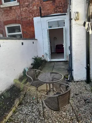 a patio with a table and chairs in front of a building at Cottage terrace Blackpool in Blackpool