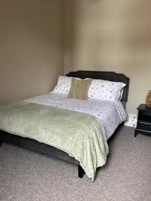 a bedroom with a bed with polka dot pillows at Homely 3 bedroom House in Liverpool in Liverpool
