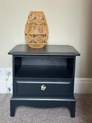 a black dresser with a basket on top of it at Homely 3 bedroom House in Liverpool in Liverpool