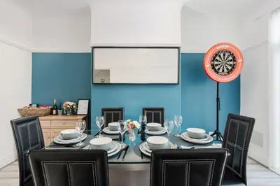 a dining room with a table and chairs at Spacious 3BR Sleeps 8 Ideal for Contractors or Large groups in Liverpool