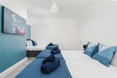 a bedroom with two beds with blue pillows on them at Spacious 3BR Sleeps 8 Ideal for Contractors or Large groups in Liverpool
