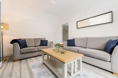 a living room with two couches and a coffee table at Spacious 3BR Sleeps 8 Ideal for Contractors or Large groups in Liverpool