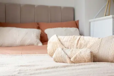 a bed with white sheets and pillows on it at #104 Luxury 4 bed beautiful house in Liverpool in Liverpool