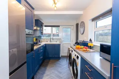 a blue and white kitchen with a sink and a dishwasher at #104 Luxury 4 bed beautiful house in Liverpool in Liverpool