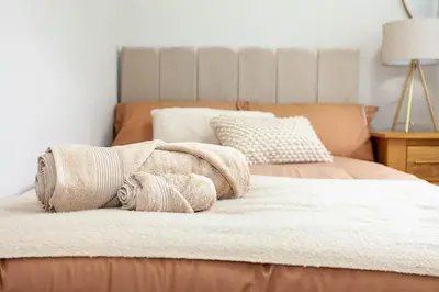a bedroom with two beds with towels on them at #104 Luxury 4 bed beautiful house in Liverpool in Liverpool