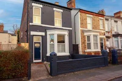 a black and white house with a porch at #104 Luxury 4 bed beautiful house in Liverpool in Liverpool