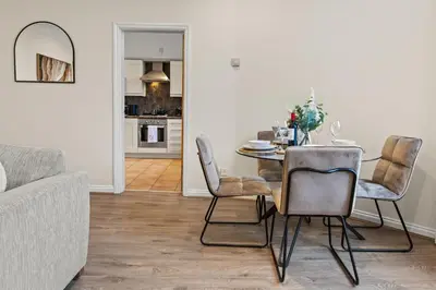 a dining room with a table and chairs at Spacious 2 Bed Apartment With Secure Free Parking in Liverpool