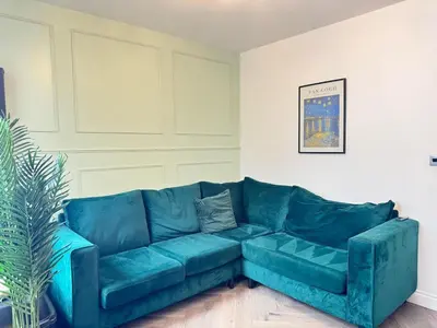 a blue couch sitting in a living room at Sleeps 12 TV in Every Room 6 Bedrooms in Liverpool
