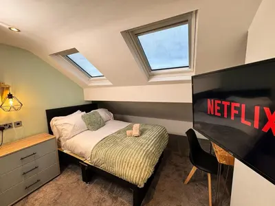 a small bedroom with a bed and a television at Sleeps 12 TV in Every Room 6 Bedrooms in Liverpool