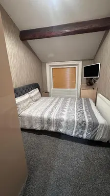 a bedroom with a large bed with a window at Fulwoodroomz in Preston