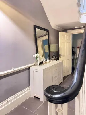 a bathroom with a black stool in front of a sink at Fulwoodroomz in Preston