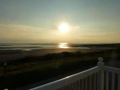 a view of the ocean and the sunset from a balcony at Shrimp Shack in Heysham