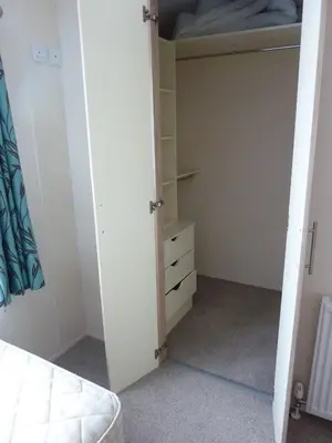 a bedroom with a bed and a closet at Shrimp Shack in Heysham