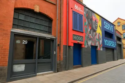 a red brick building with two doors and a sign on it at Prime City Apt with Parking - Steps to Bars & Trains in Liverpool