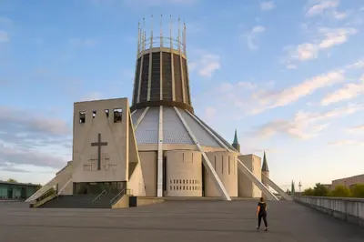 a woman is standing in front of a church at Prime City Apt with Parking - Steps to Bars & Trains in Liverpool