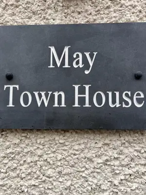 a sign for a may town house on a building at May Townhouse in Ulverston
