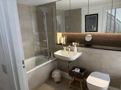 a bathroom with a sink and a shower and a toilet at May Townhouse in Ulverston