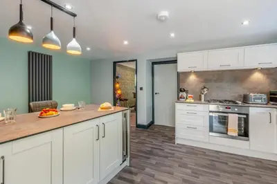 a kitchen with white cabinets and a counter top at 3 Bed in Southport oc-h32625 in Southport
