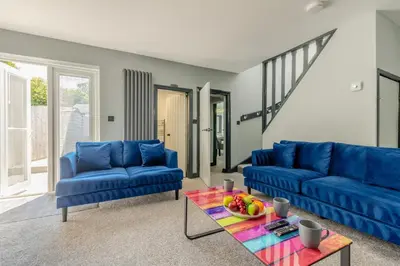 a living room with blue couches and a table at 3 Bed in Southport oc-h32625 in Southport