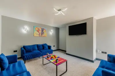 a living room with blue couches and a tv at 3 Bed in Southport oc-h32625 in Southport