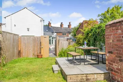 a patio with a table and benches in a backyard at 2 Bed in Southport oc-h32626 in Southport