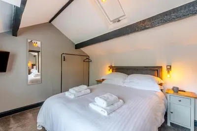 a bedroom with a large white bed with towels on it at 2 Bed in Southport oc-h32626 in Southport