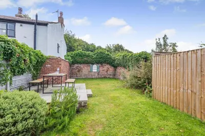 a garden with a table and benches and a fence at 2 Bed in Southport oc-h32626 in Southport