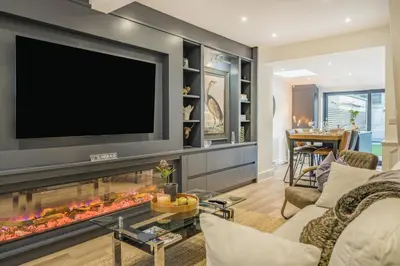 a living room with a fireplace with a flat screen tv at 3 Bed in Ulverston oc-m34782 in Ulverston