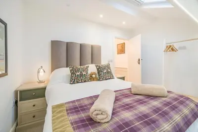 a bedroom with a large bed with a purple blanket at 3 Bed in Ulverston oc-m34782 in Ulverston
