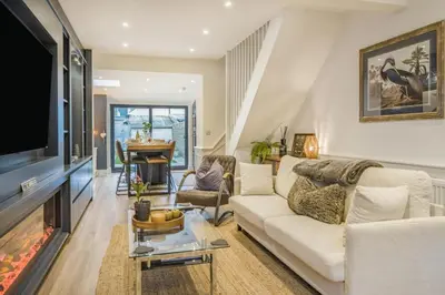 a living room with a white couch and a fireplace at 3 Bed in Ulverston oc-m34782 in Ulverston