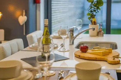 a table with a bottle of wine and glasses on it at 3 Bed in Ulverston oc-m34782 in Ulverston