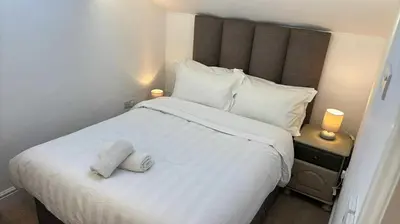 a bedroom with a white bed with two towels on it at 3 Bed in Ulverston oc-m34782 in Ulverston