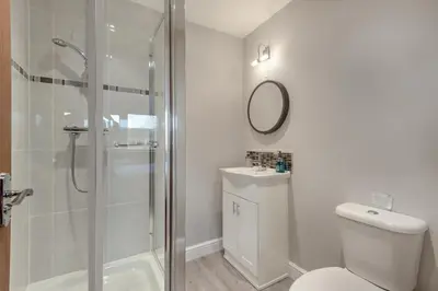 a bathroom with a shower and a toilet and a sink at 2 Bed in Carnforth oc-s34803 in Warton