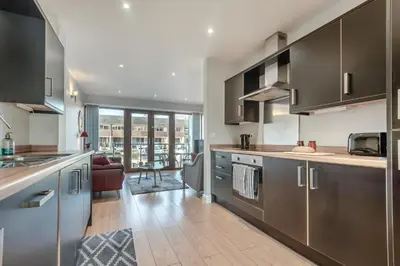 a kitchen with stainless steel appliances and a living room at 2 Bed in Carnforth oc-s34803 in Warton