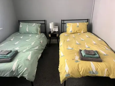 a bedroom with two beds with towels on them at Greenways House in Lancaster