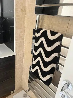 a shower with a black and white towel at Greenways House in Lancaster