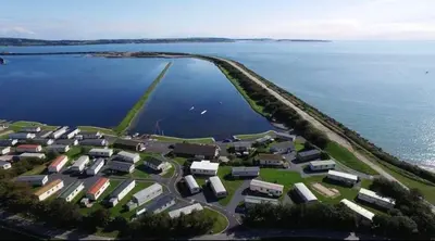 an aerial view of a small village by the water at Lisas Lodge in the Lake District in Millom