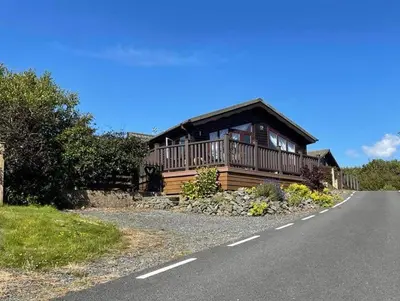 a house on the side of a road at Lisas Lodge in the Lake District in Millom