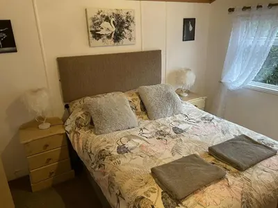 a bed with two pillows on it in a bedroom at Lisas Lodge in the Lake District in Millom