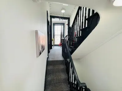 a stairway with black railings in a building at 12B Classy Bedroom in a Shared home at Pembroke in Liverpool