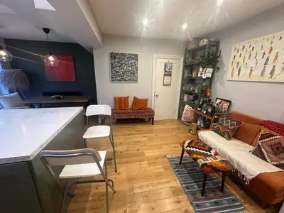 a living room with a couch and a table at Golf open - walking distance in Ainsdale