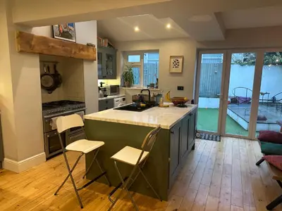 a kitchen with an island with a counter top at Golf open - walking distance in Ainsdale