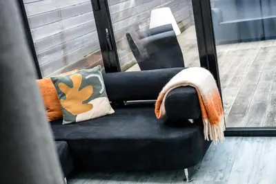 a chair with a blanket on it sitting next to a window at Cemeas House - Air Host & Stay - Slps 6 - Parking in Liverpool