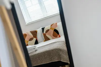 a mirror reflection of a bed in a room at Cemeas House - Air Host & Stay - Slps 6 - Parking in Liverpool