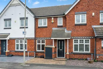 a red brick house with a black door at Cemeas House - Air Host & Stay - Slps 6 - Parking in Liverpool