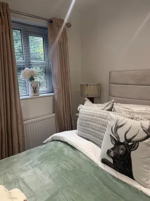 a bedroom with a bed with a deer pillow on it at Cozy bungalow in Standish