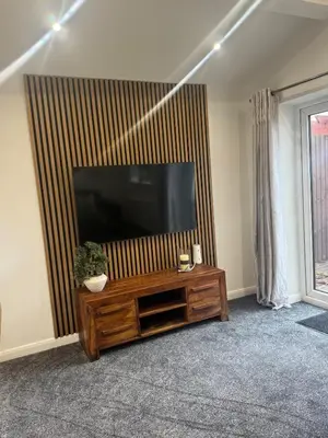 a living room with a large flat screen tv at Cozy bungalow in Standish
