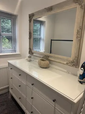 a dresser with a large mirror on top of it at Cozy bungalow in Standish