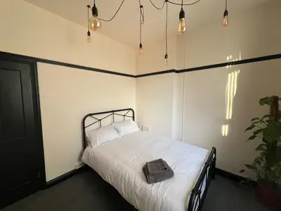 a bedroom with a bed with a bag on it at Reevell Avenue in Liverpool